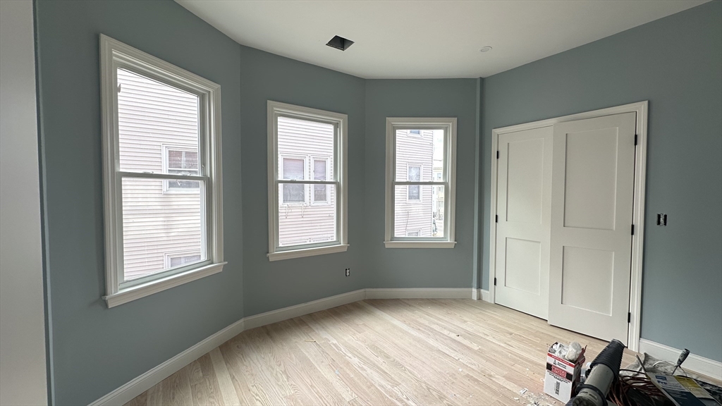 663 Columbia Road, Unit 1 Boston, MA 02125 - Photo 10 of 12 an empty room with windows