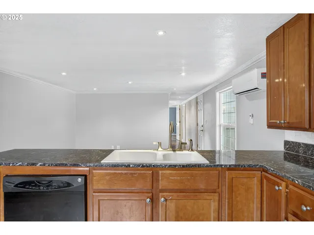 a kitchen with stainless steel appliances granite countertop a sink and cabinets