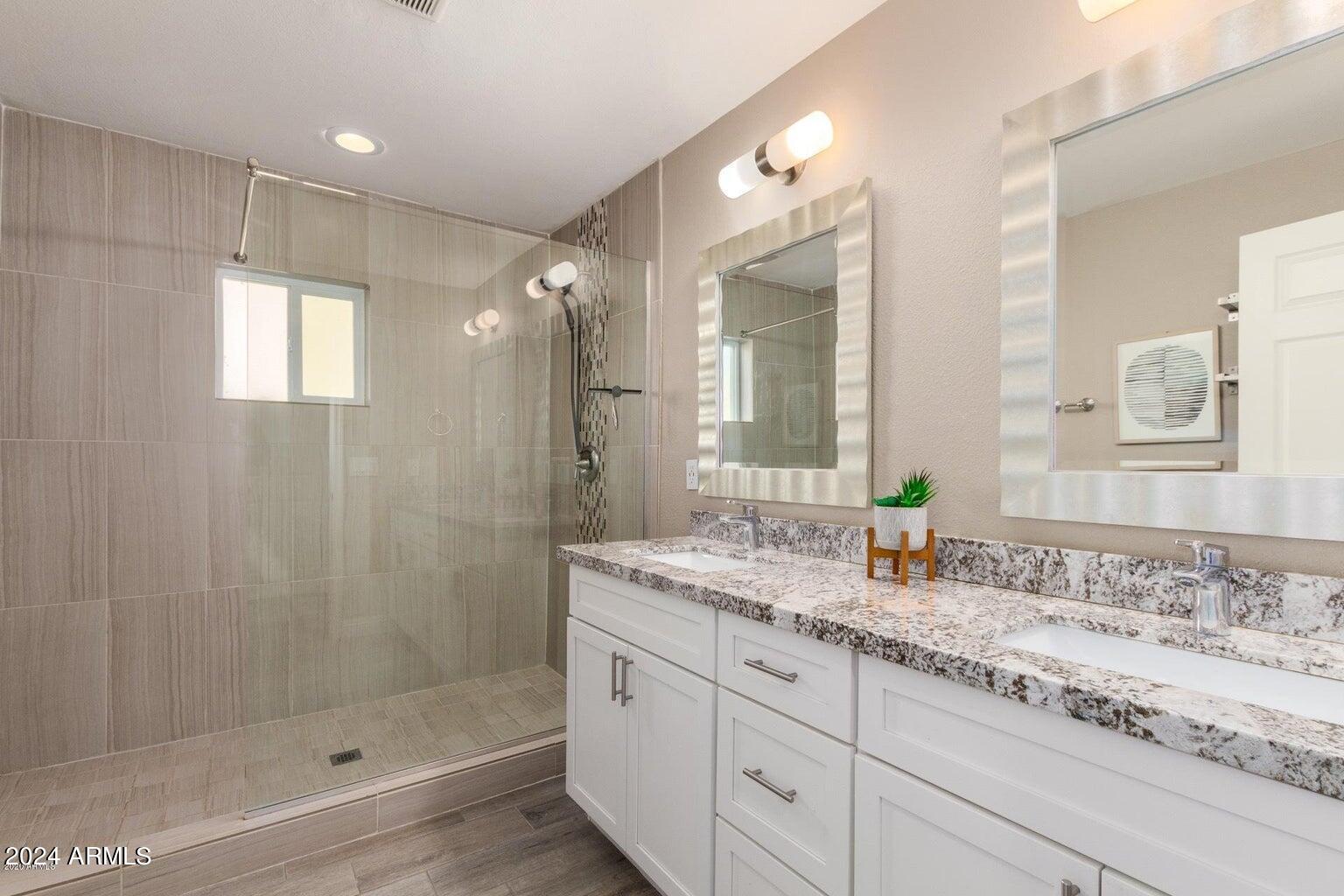 2350 North 55th Street Phoenix, AZ 85008 - Photo 10 of 20 a bathroom with a granite countertop sink mirror and shower