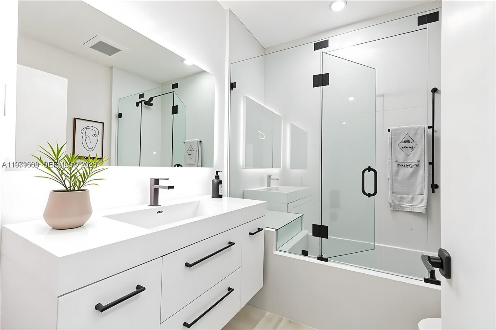 2251 Southwest 20th Street Miami, FL 33145 - Photo 25 of 36 a bathroom with a tub sink vanity granite and a shower