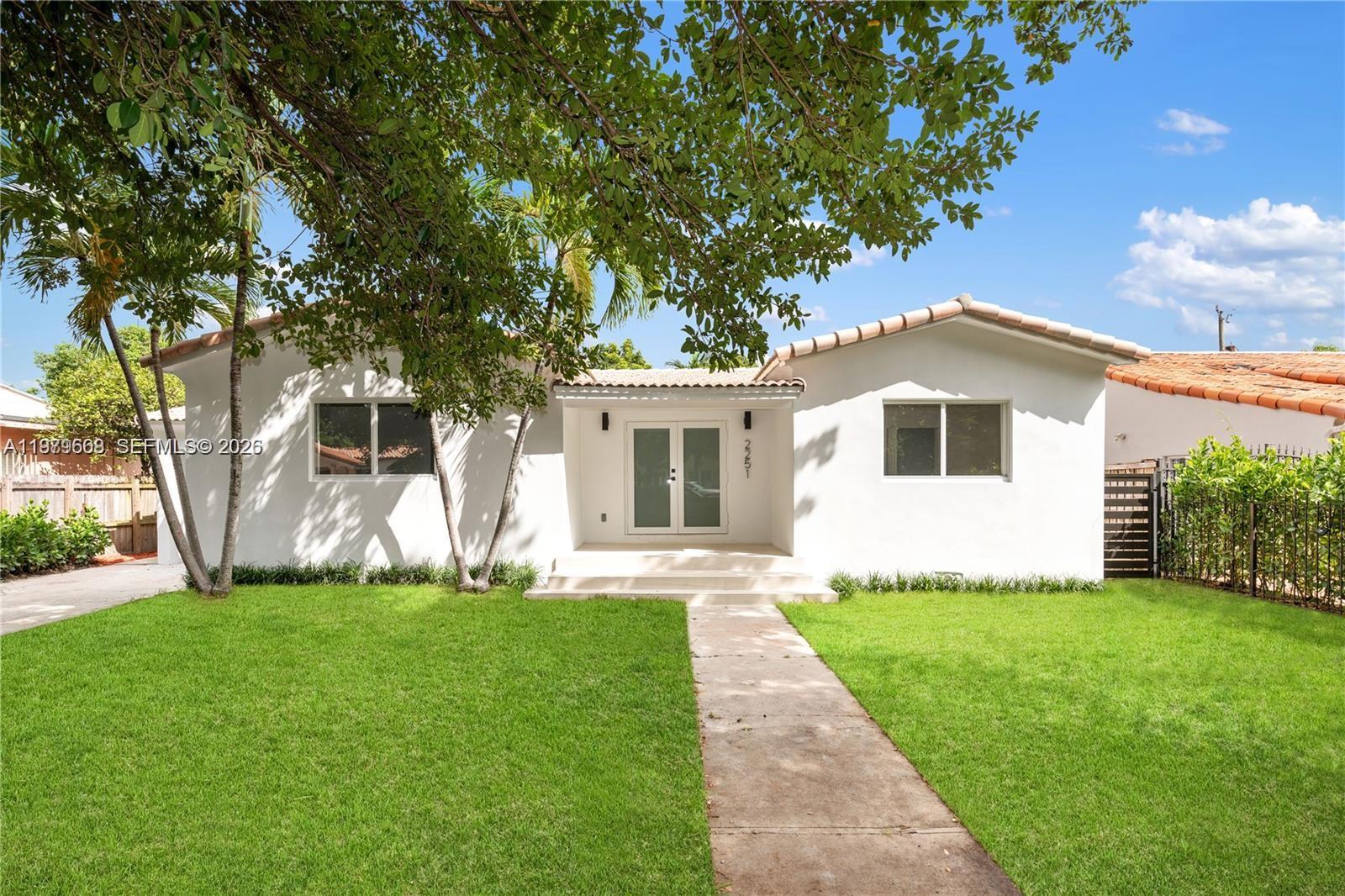 2251 Southwest 20th Street Miami, FL 33145 - Photo 36 of 36 a front view of a house with a garden and yard