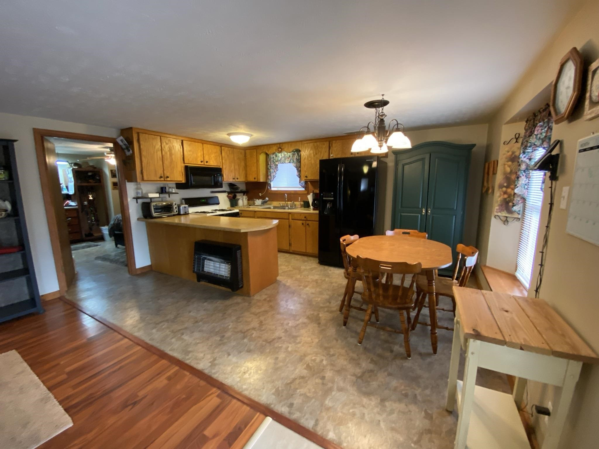 3520 Silerton Road Henderson, TN 38340 - Photo 2 of 24 a kitchen with a table chairs refrigerator and furniture