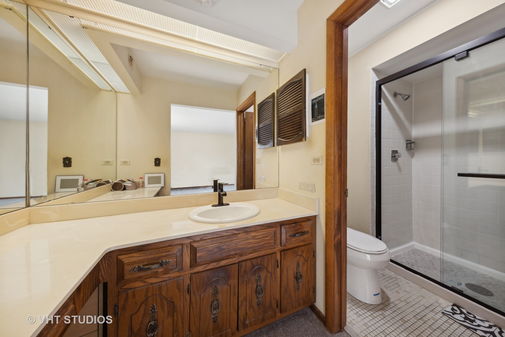 6685 Breckenridge Road Lisle, IL 60532 - Photo 13 of 18 a spacious bathroom with a granite countertop sink a toilet a mirror and shower