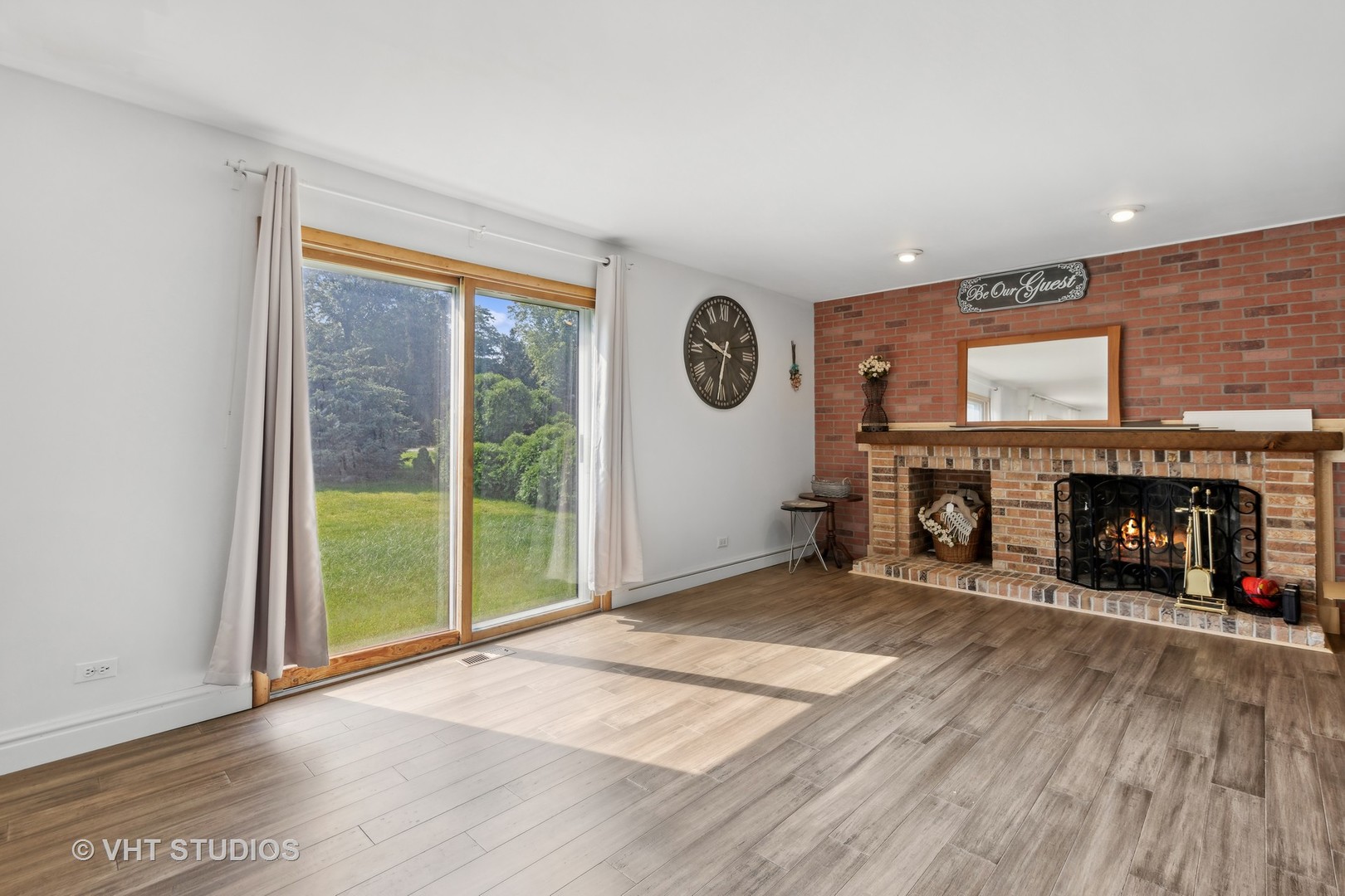 6685 Breckenridge Road Lisle, IL 60532 - Photo 9 of 18 a view of an empty room with a fireplace and a window