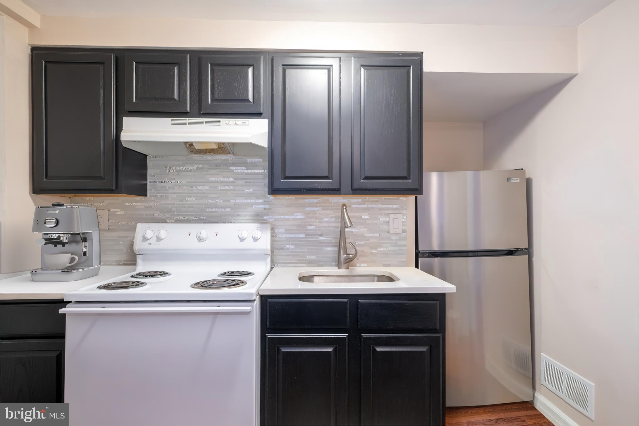 1736 Pine Street, Unit 3R Philadelphia, PA 19103 - Photo 4 of 14 a kitchen with a sink and a refrigerator