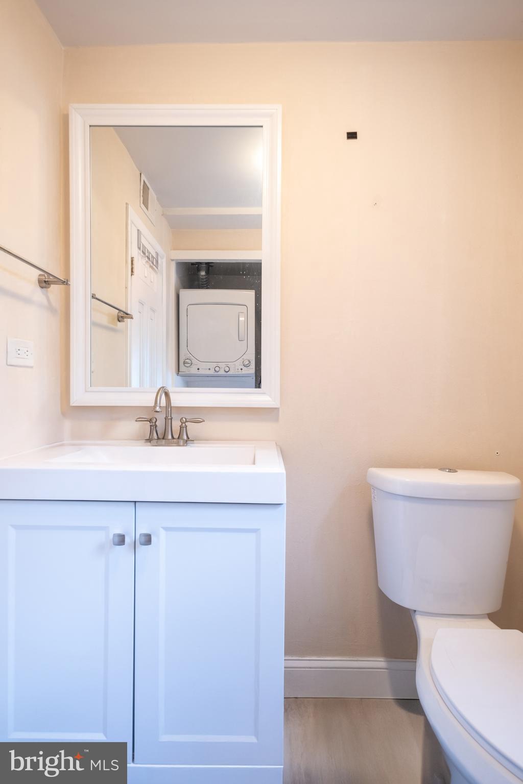 1736 Pine Street, Unit 3R Philadelphia, PA 19103 - Photo 9 of 14 a bathroom with a toilet a sink and mirror
