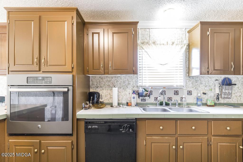 100 Coventry Manor Court Byron, GA 31008 - Photo 13 of 29 a kitchen with stainless steel appliances granite countertop a sink a stove and cabinets