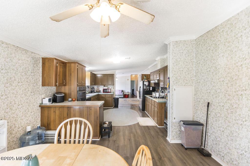 100 Coventry Manor Court Byron, GA 31008 - Photo 17 of 29 a kitchen with a table chairs appliances and cabinets