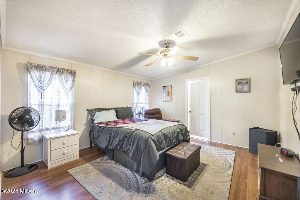 100 Coventry Manor Court Byron, GA 31008 - Photo 18 of 29 a bedroom with a bed and a chandelier