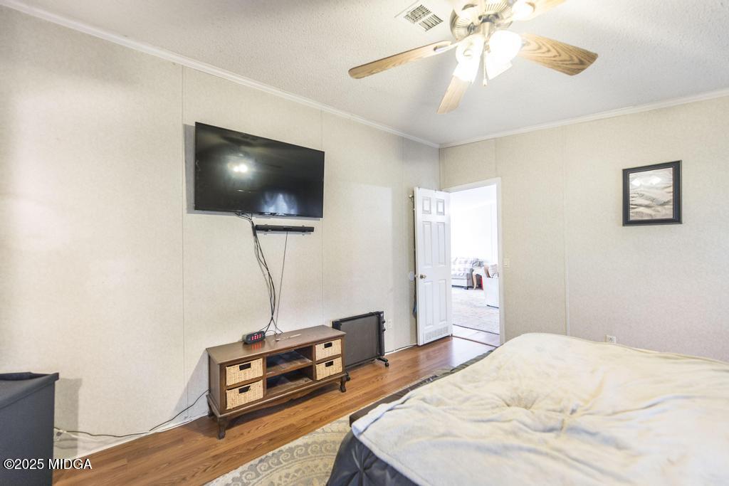 100 Coventry Manor Court Byron, GA 31008 - Photo 19 of 29 a bedroom with a bed and a flat screen tv