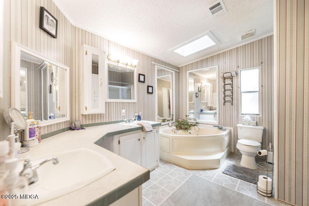 100 Coventry Manor Court Byron, GA 31008 - Photo 20 of 29 a bathroom with a tub a sink and a large mirror
