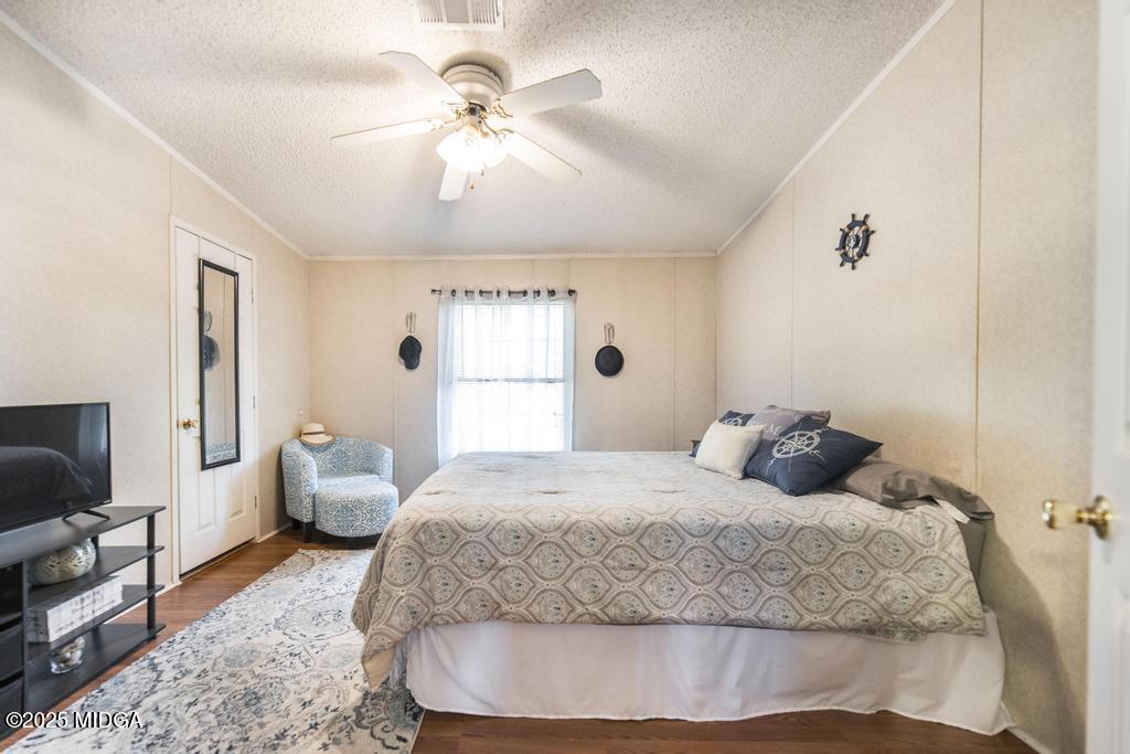 100 Coventry Manor Court Byron, GA 31008 - Photo 25 of 29 a bedroom with a bed and a flat screen tv