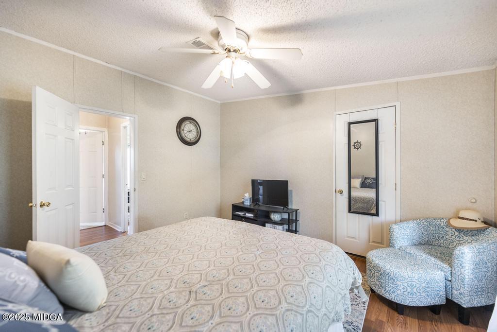 100 Coventry Manor Court Byron, GA 31008 - Photo 26 of 29 a bedroom with a bed and a chandelier