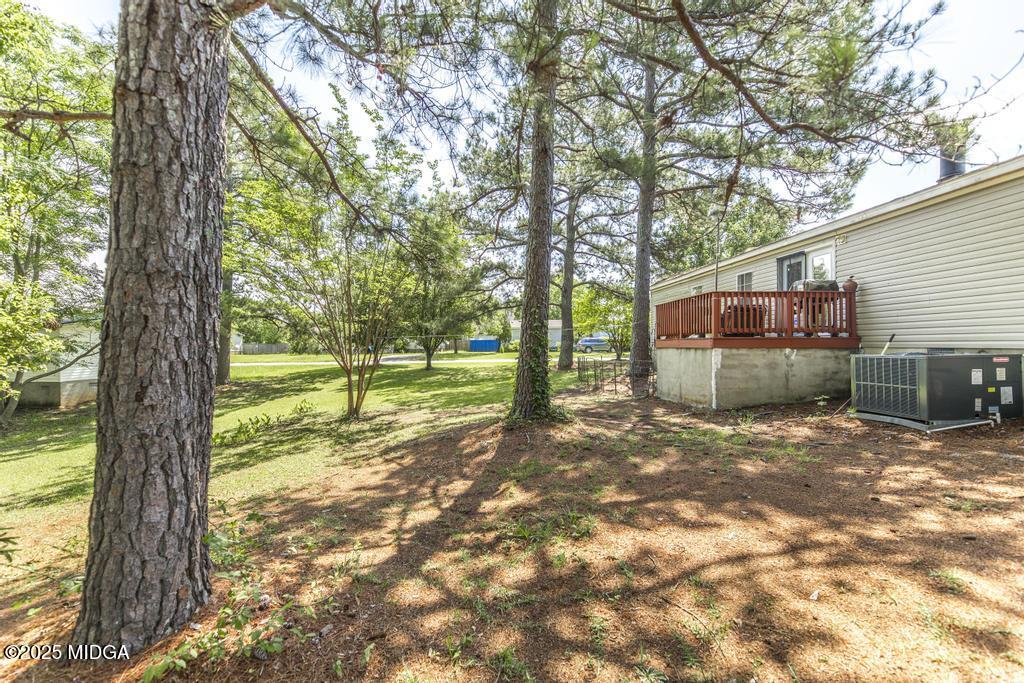 100 Coventry Manor Court Byron, GA 31008 - Photo 28 of 29 a view of a backyard with large trees and a barn