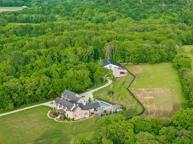 a view of multiple house with large trees