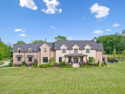a large white kitchen with a sink and dishwasher