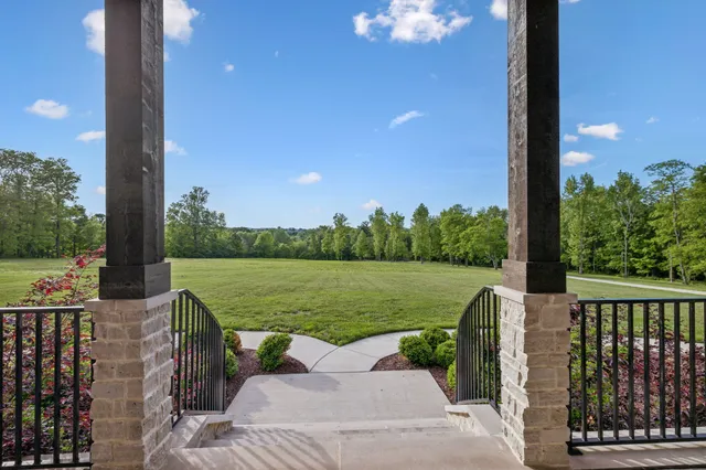 a room with a bed a chandelier and mirror