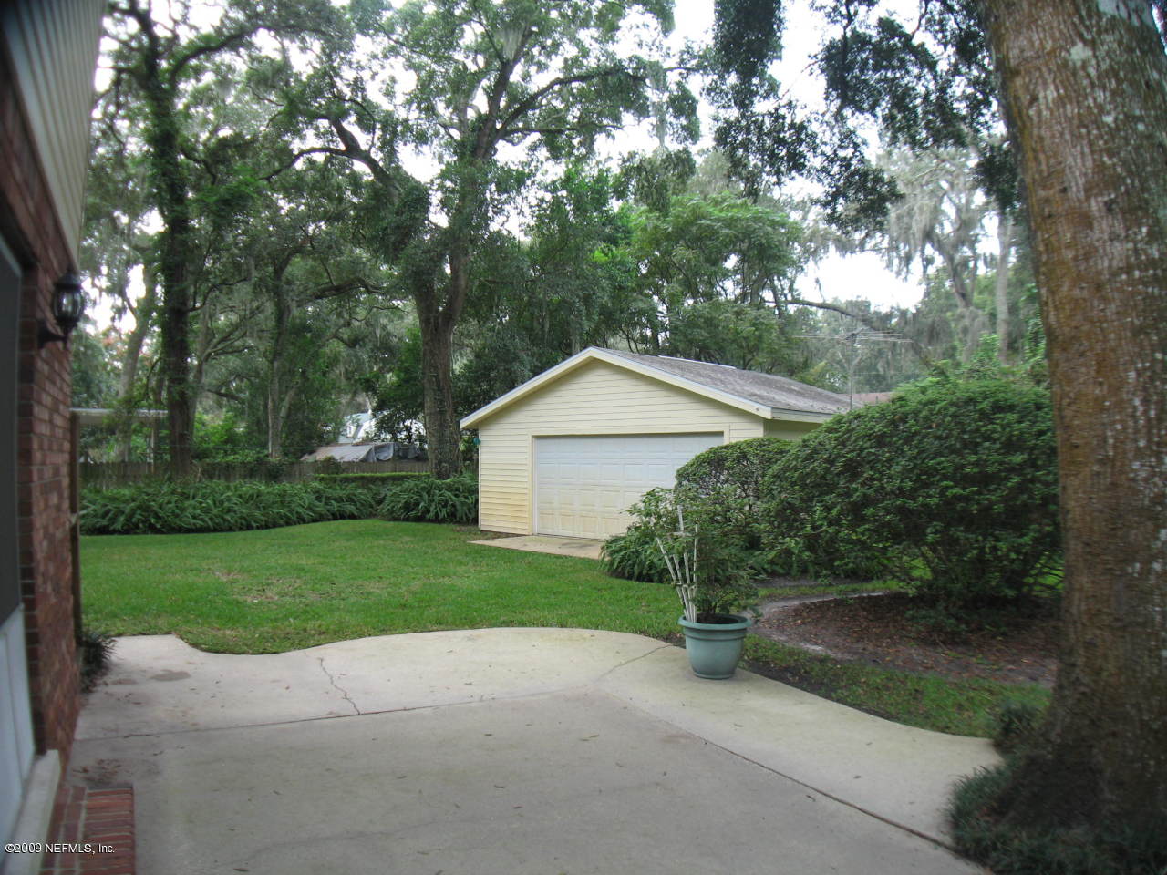4154 Rogero Road Jacksonville, FL 32277 - Photo 31 of 31 a view of a house with a yard and large tree