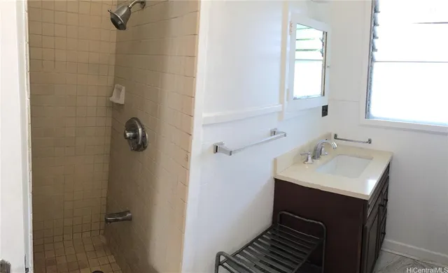 a bathroom with a sink a mirror and shower