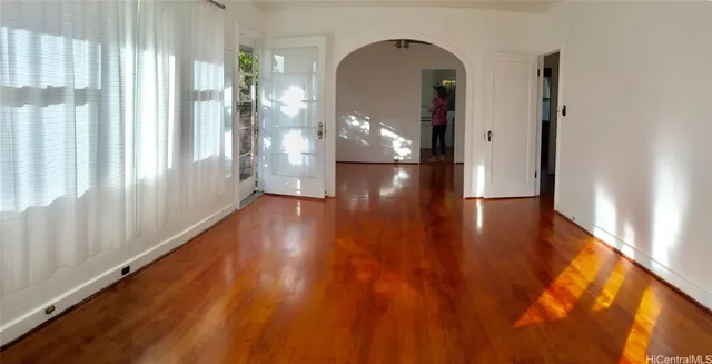 a view of a hallway with wooden floor