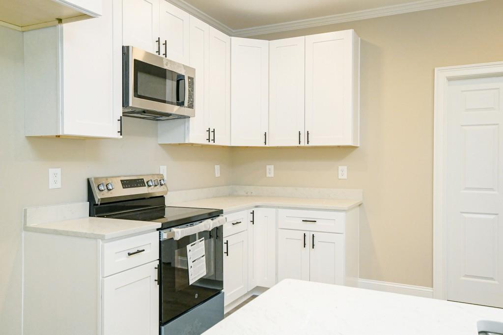 5342 Monarch Drive Gainesville, GA 30506 - Photo 13 of 27 a kitchen with white cabinets stainless steel appliances and sink