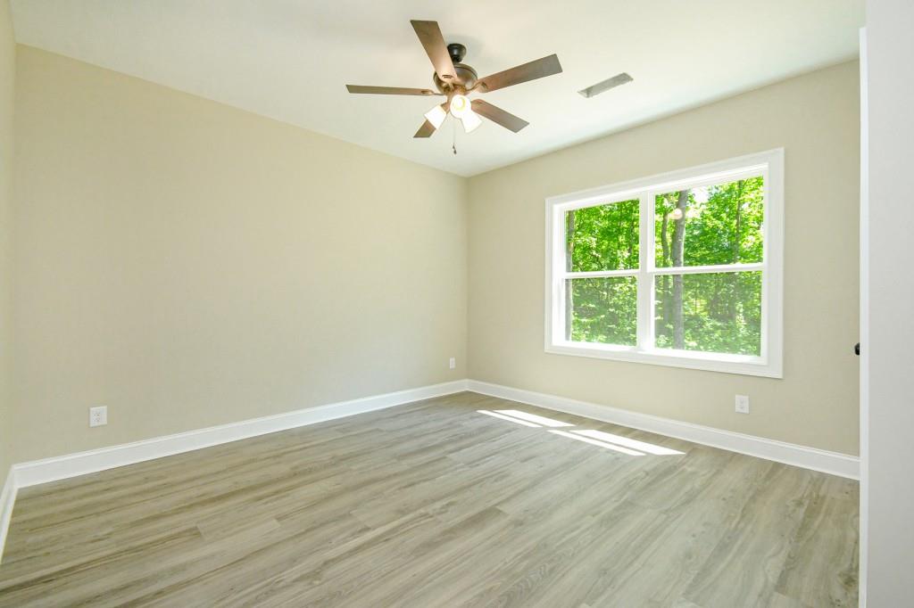 5342 Monarch Drive Gainesville, GA 30506 - Photo 19 of 27 an empty room with wooden floor and windows