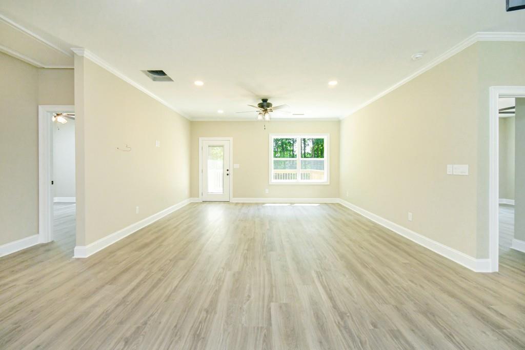 5342 Monarch Drive Gainesville, GA 30506 - Photo 6 of 27 an empty room with wooden floor and windows