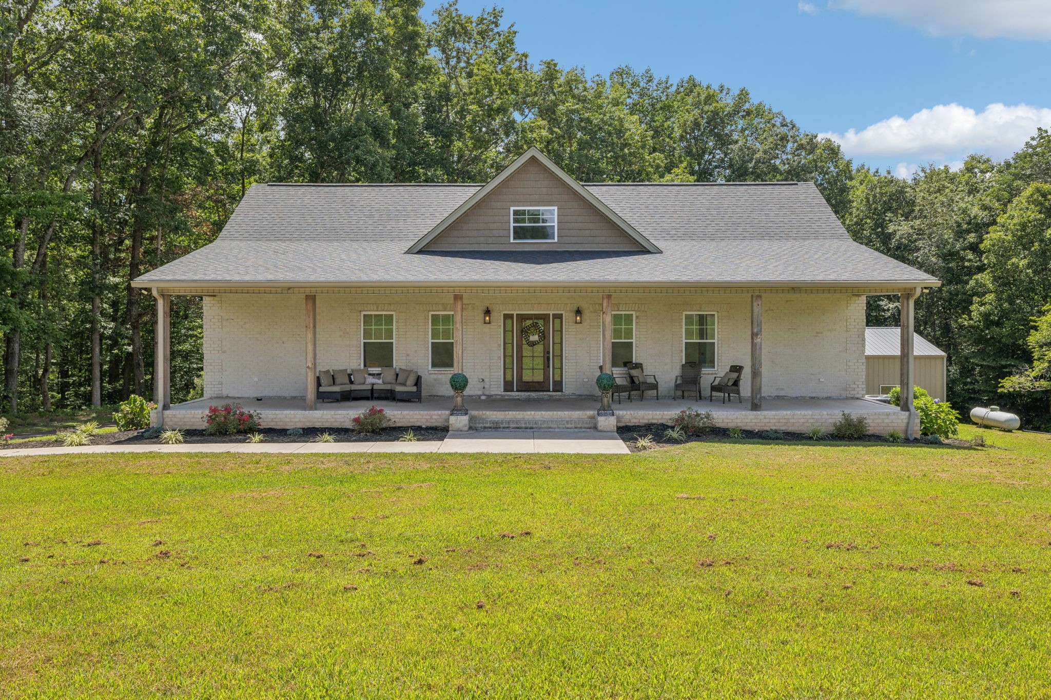 a view of a house with swimming pool and sitting area