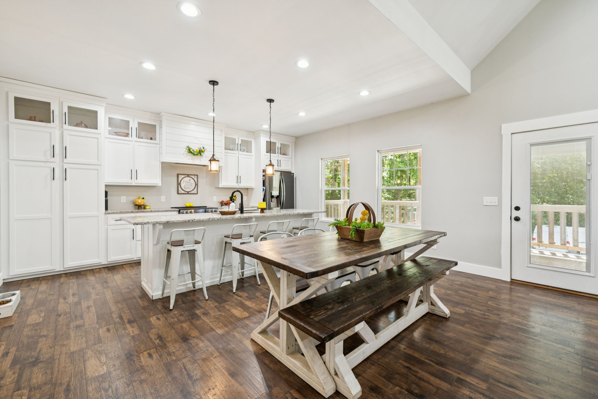977 Elzie Williams Road Red Boiling Springs, TN 37150 - Photo 17 of 52 a room with stainless steel appliances kitchen island granite countertop a table chairs and a refrigerator