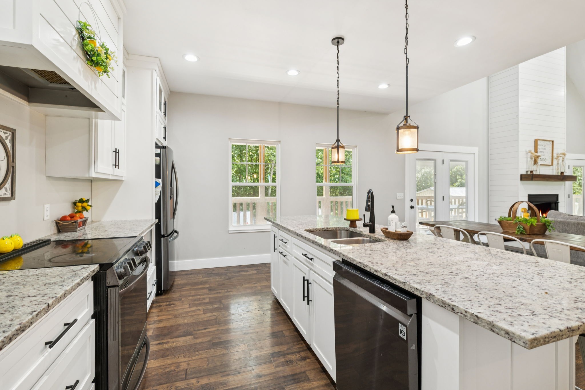 977 Elzie Williams Road Red Boiling Springs, TN 37150 - Photo 22 of 52 a kitchen with stainless steel appliances granite countertop a sink a stove and a wooden floors