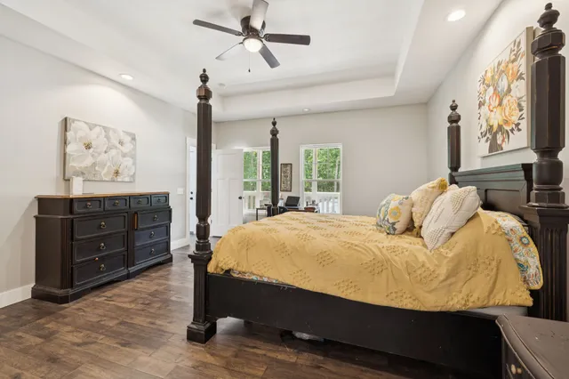 a en suite bathroom with a granite countertop double vanity sink and a mirror