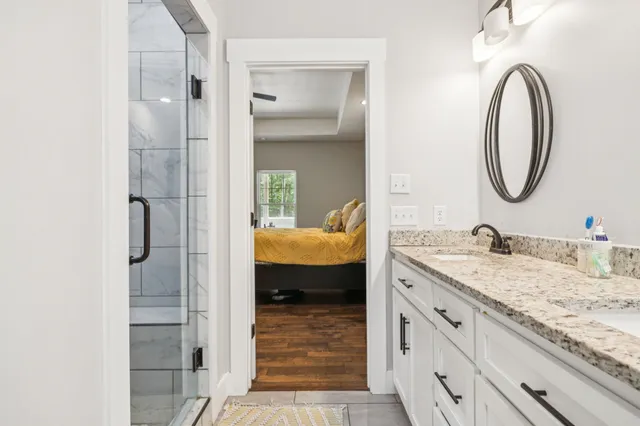 a bathroom with a granite countertop sink a mirror and a