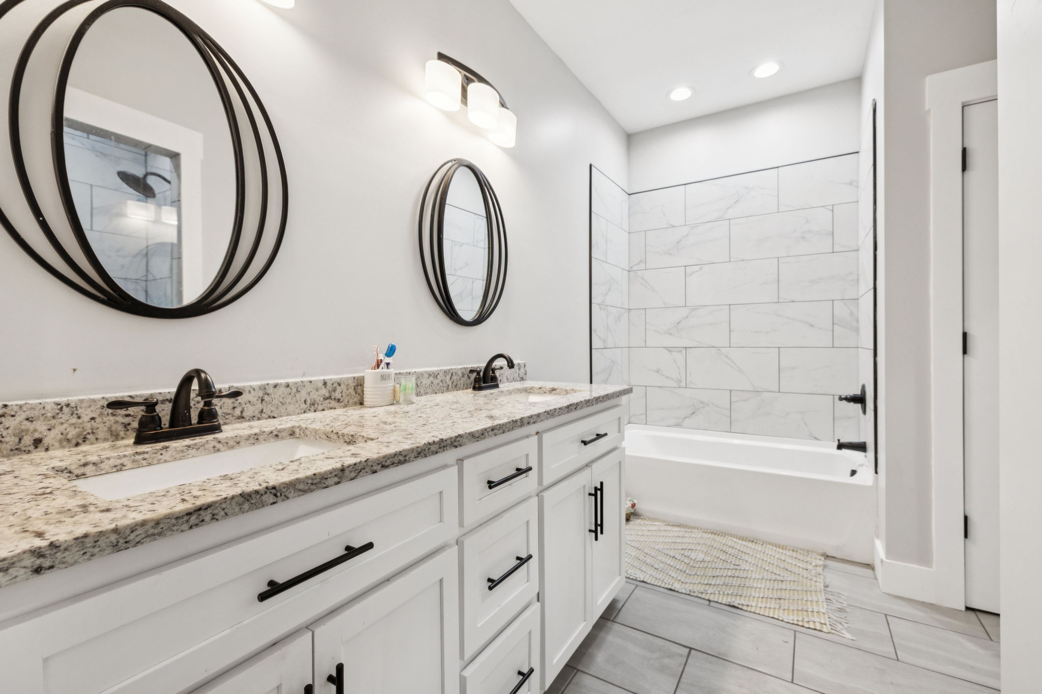 977 Elzie Williams Road Red Boiling Springs, TN 37150 - Photo 27 of 52 a bathroom with a granite countertop sink a mirror and a