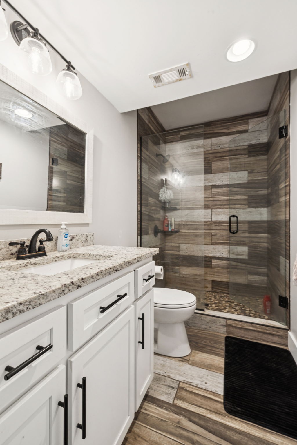 977 Elzie Williams Road Red Boiling Springs, TN 37150 - Photo 35 of 52 a bathroom with a granite countertop sink toilet and shower