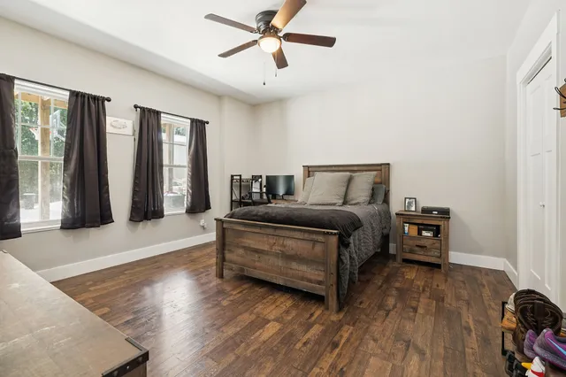 a bedroom with a bed and a ceiling fan
