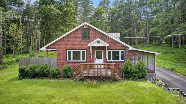 a front view of a house with a yard table and chairs