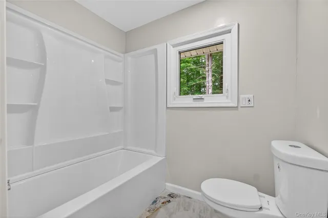 a bathroom with a sink a toilet and bathtub