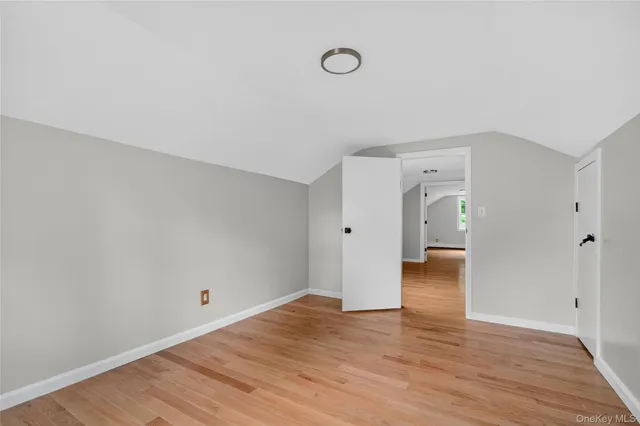 a view of a room with wooden floor and window