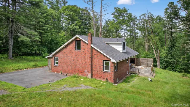 a view of a house with backyard and sitting area
