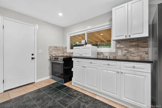 a view of a kitchen with a sink stainless steel appliances and cabinets