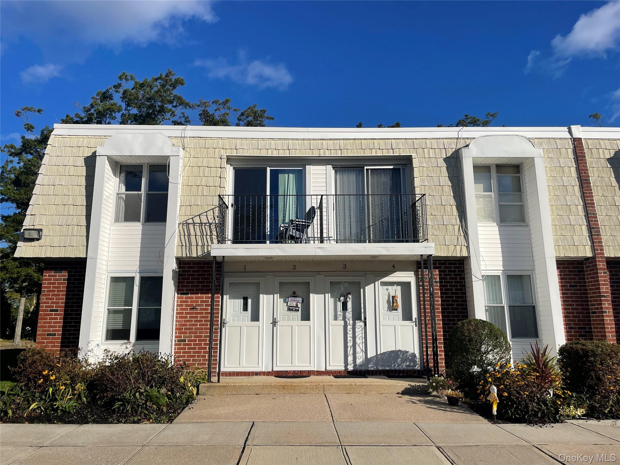51 Rocky Point Yaphank Road, Unit 2 Rocky Point, NY 11778 - Photo 1 of 14 a view of a building with a entrance