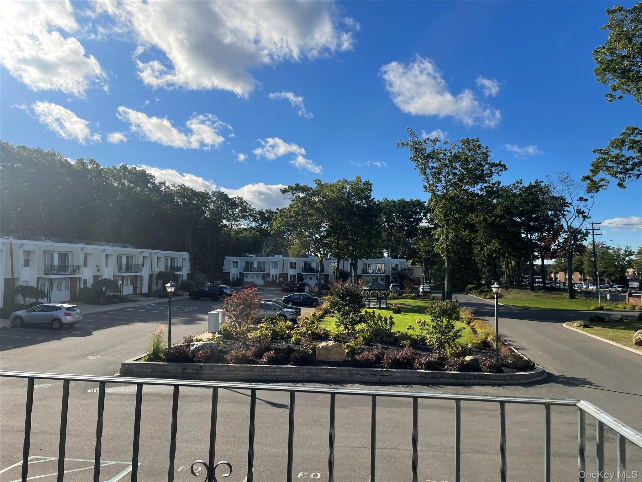 51 Rocky Point Yaphank Road, Unit 2 Rocky Point, NY 11778 - Photo 13 of 14 a street view with a garden