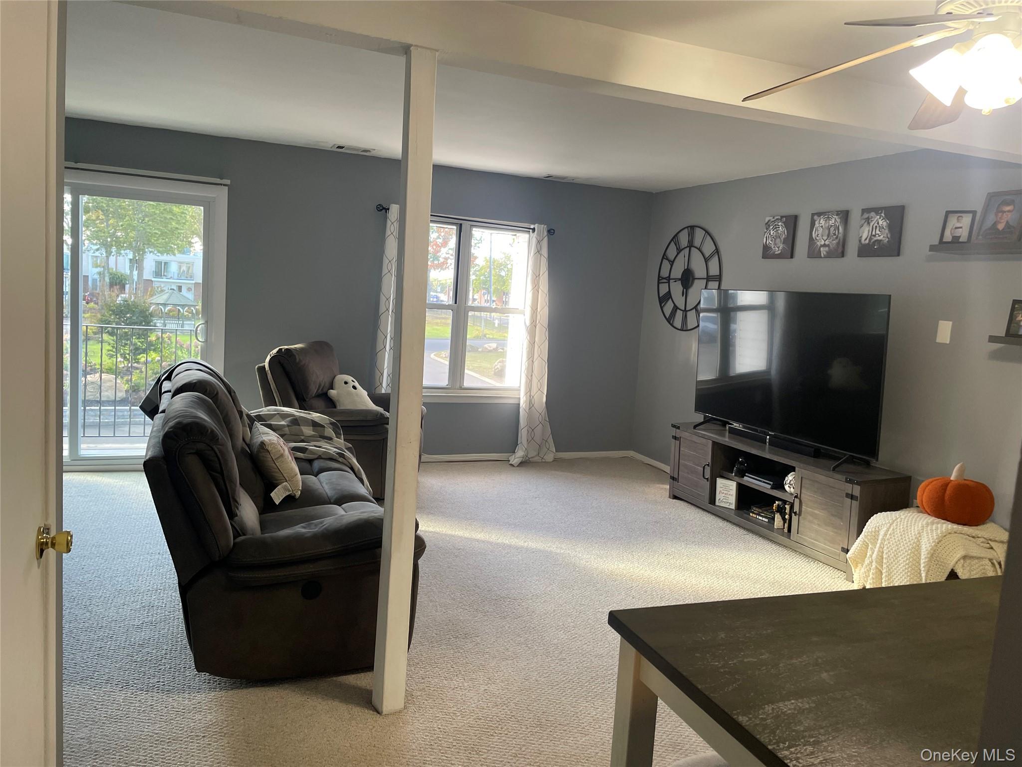 51 Rocky Point Yaphank Road, Unit 2 Rocky Point, NY 11778 - Photo 3 of 14 a living room with furniture and a flat screen tv
