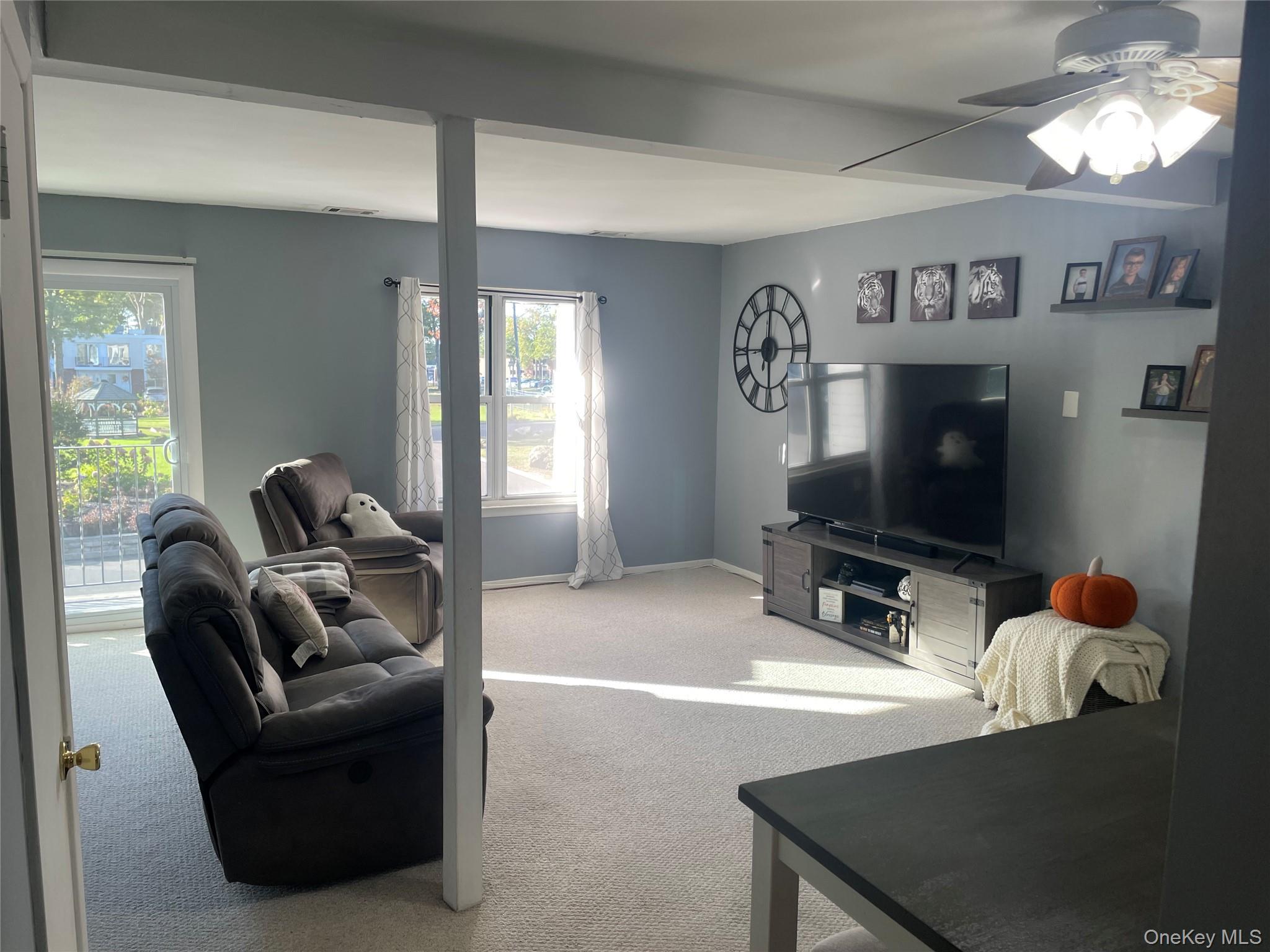 51 Rocky Point Yaphank Road, Unit 2 Rocky Point, NY 11778 - Photo 5 of 14 a living room with furniture and a flat screen tv