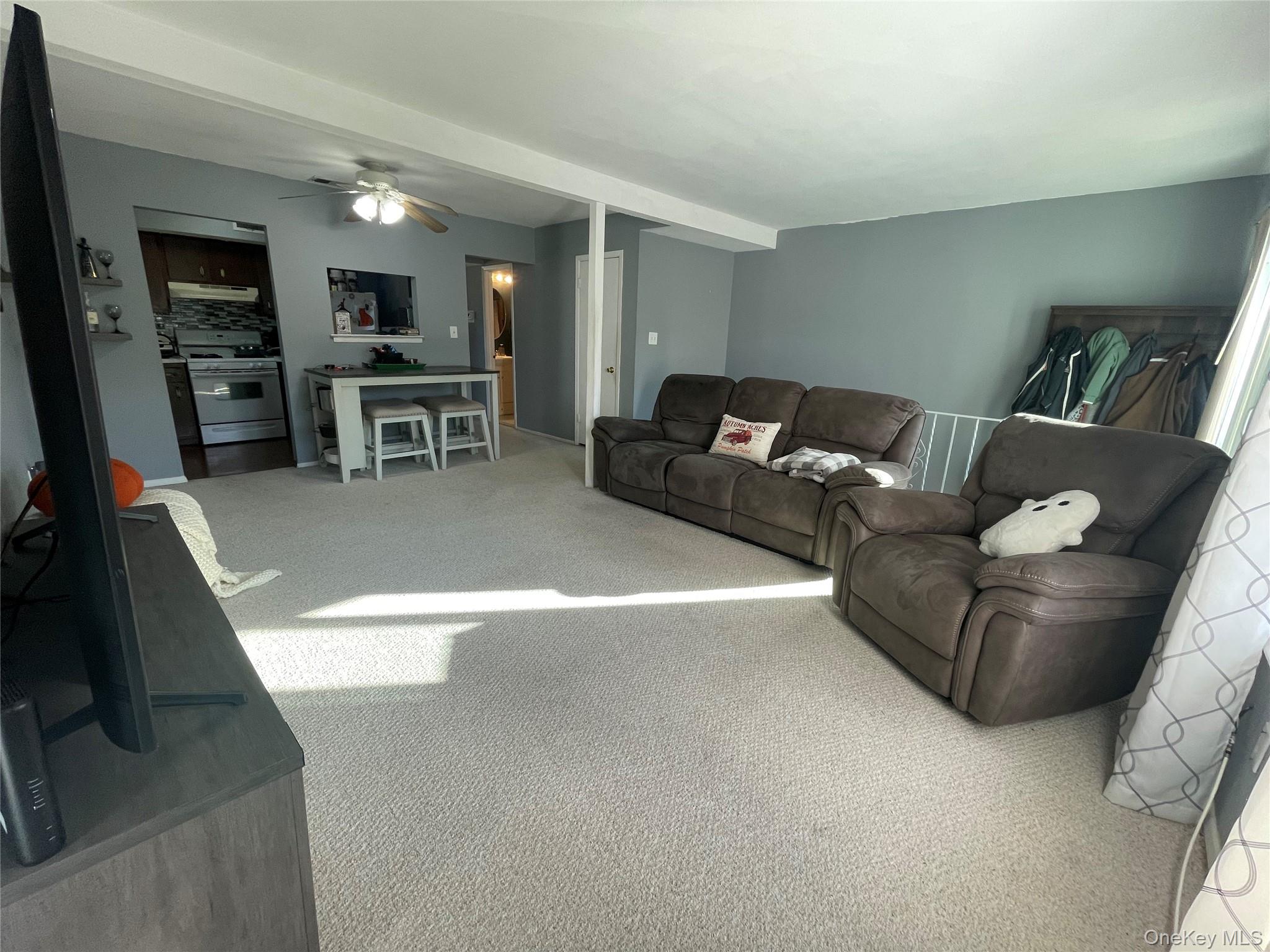 51 Rocky Point Yaphank Road, Unit 2 Rocky Point, NY 11778 - Photo 6 of 14 a living room with furniture and a table