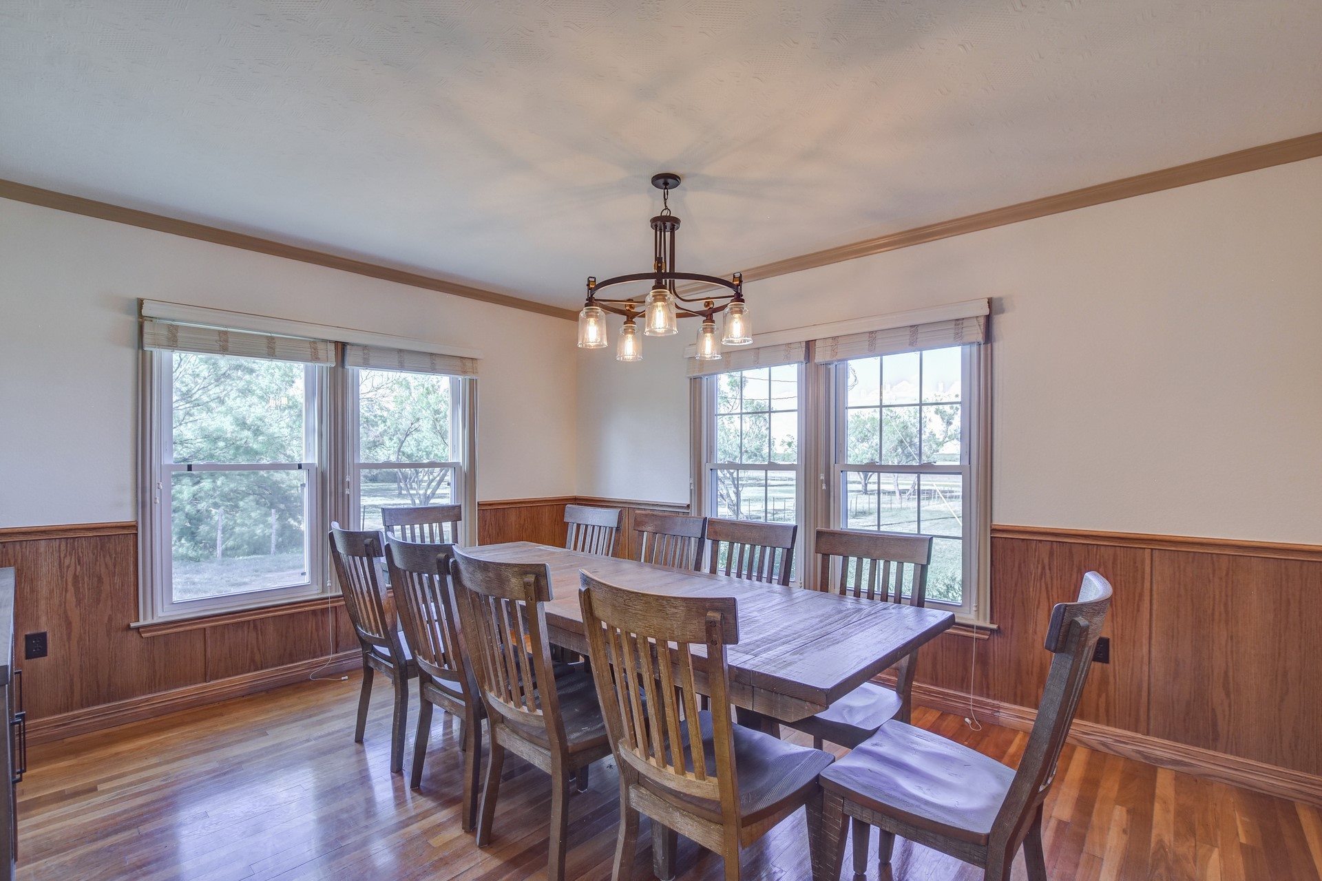 18601 County Road 214 Brookesmith, TX 76827 - Photo 32 of 39 Hunter's Cabin: Formal dining room featuring wainscoting, wood walls, wood finished floors, crown molding, and a chandelier