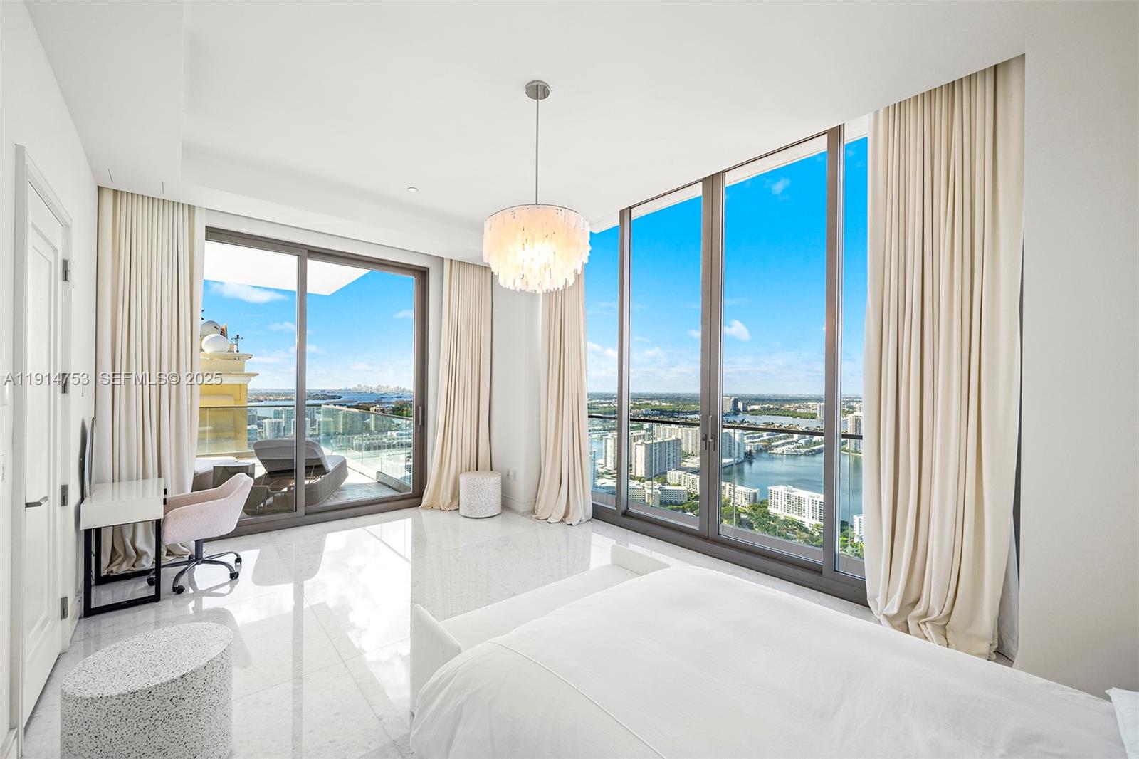 17901 Collins Avenue, Unit 4507 Sunny Isles Beach, FL 33160 - Photo 18 of 58 a bedroom with furniture and large windows