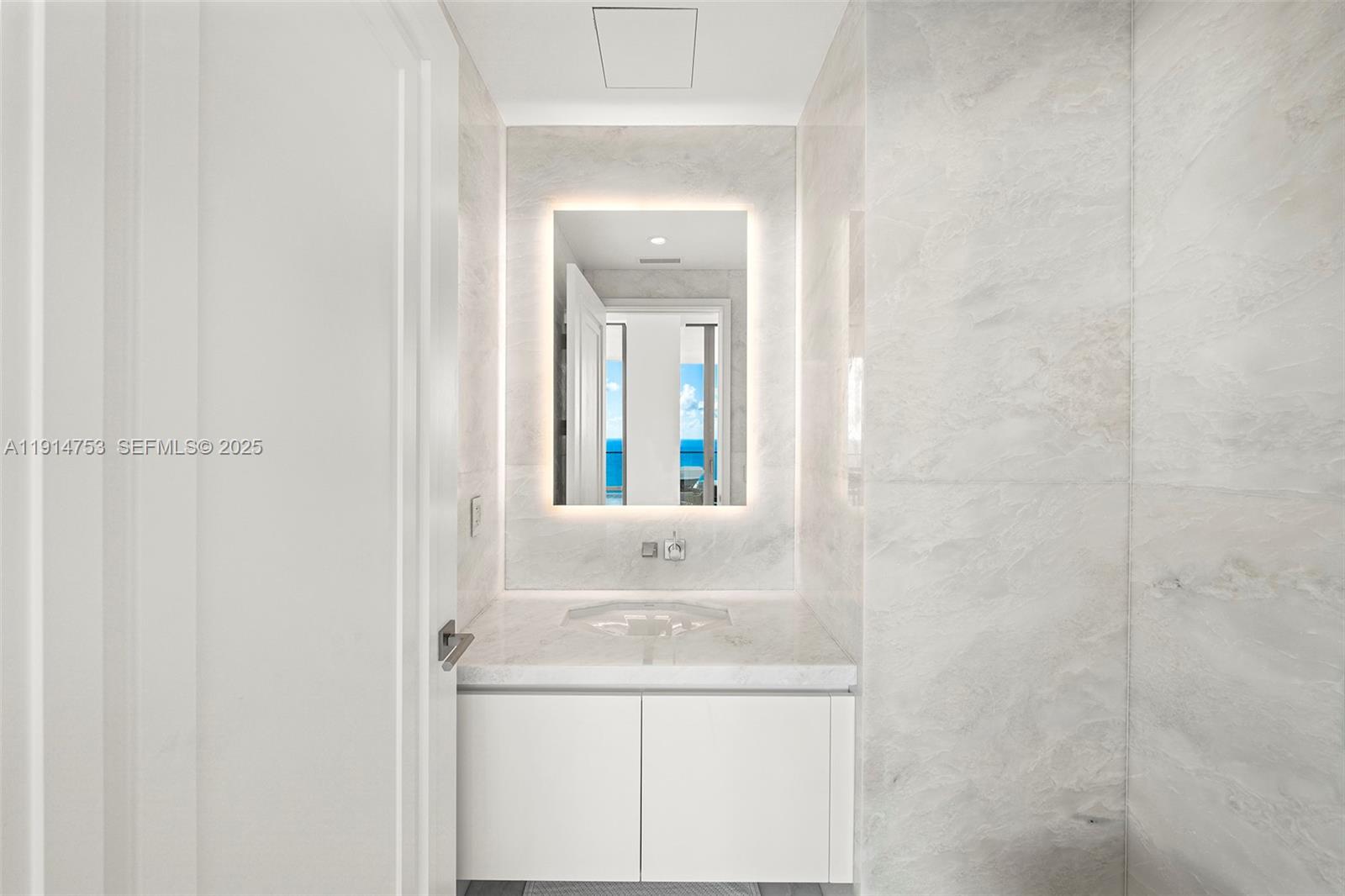 17901 Collins Avenue, Unit 4507 Sunny Isles Beach, FL 33160 - Photo 23 of 58 a bathroom with a sink and a mirror