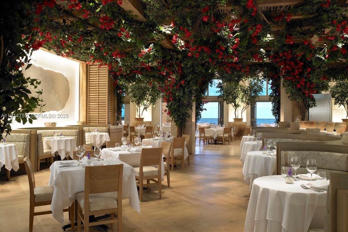 17901 Collins Avenue, Unit 4507 Sunny Isles Beach, FL 33160 - Photo 42 of 58 a view of a patio with couches table and chairs and potted plants