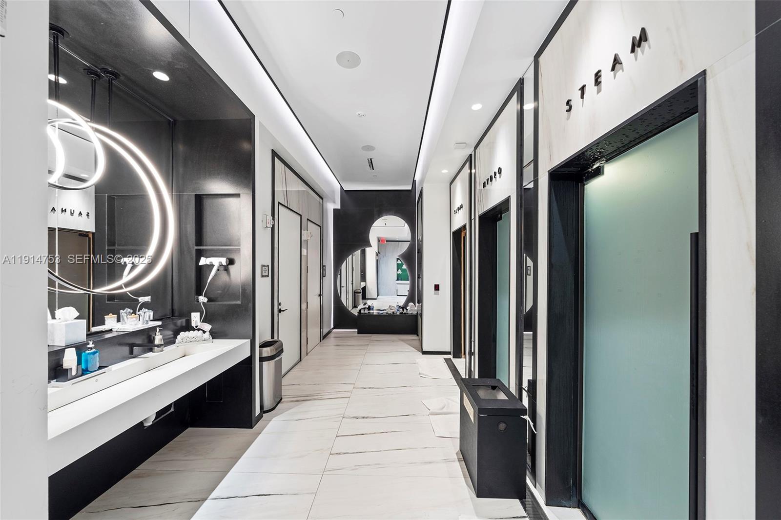 17901 Collins Avenue, Unit 4507 Sunny Isles Beach, FL 33160 - Photo 46 of 58 a en suite bathroom with a double vanity sink and a mirror